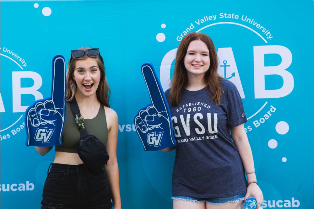 two students posing in front of photo backdrop at Laker Kickoff photo booth